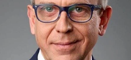A person wearing eyewear rests their chin on their hand, their glasses perched on their forehead, framed by their cheek and eyebrow. Vision care for a clear-sighted face.