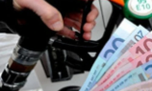Fuel dispensers at a filling station displaying logos and advertisements for Excell diesel fuel. Station offers various fuel options.